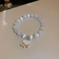 Detail view of ethnic style cat's eye beaded bracelet with a gold Ruyi lock pendant - Ruyi Lock Style (19#)