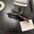 Leopard print hair claw clip with black bow detail on a dark elegant background - Bowknot Cross Wave Style / Black/Coffee Leopard Style