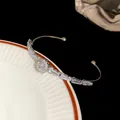 Detailed view of luxury silver cuff bracelet featuring sparkling round and baguette zircons - Round / Silver