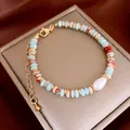 Ethnic style beaded bracelet with blue stones and a baroque pearl in golden finish - Blue and Red Style (51#)