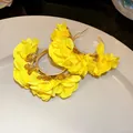 Detailed view of yellow chiffon flower C-shaped hoop earrings for a beach vacation style - C-Shape Floral Style (HE30814) / Yellow
