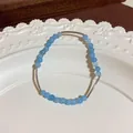 Ethnic style beaded bracelet featuring sky blue crystal beads and silver curved tube accents - Crystal Beads with Curved Tube Style (Style 75) / Silver-Blue