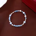 Elegant blue crystal and white pearl beaded bracelet with silver spacers on brown fabric - Wave Spacer Crystal Style (Style 81) / Silver-Blue