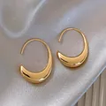 Detailed macro view of golden minimalist geometric crescent earrings on champagne silk - 44# Ear Hook - Gold