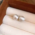 Detailed macro view of minimalist brushed metallic spherical stud earrings in a jewelry box - 46# Silver Needle - 10mm Silver