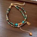 Bohemian ethnic multi-layered beaded bracelet with turquoise and gold charm details. - Style 101 Bracelet / Green & Blue