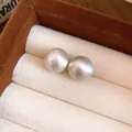 Macro detail of elegant silver satin-finish spherical stud earrings in a jewelry box - 48# Silver Needle - Silver 12mm
