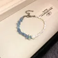 Handmade beaded bracelet with blue crystals and white shell beads in a vintage style - Style 105 Bracelet / Blue & White