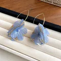 Close-up of elegant blue fabric flower earrings with hollow gold metal details. - Flower Style (HE25162) / Blue
