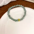 Elegant light green jadeite-style beaded bracelet with a textured golden accent charm - Fortune Bead New Chinese Style (75#) / Green