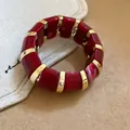Red marbled acrylic bracelet with gold-toned spacers, elegant and minimalist design. - Deep Red Marble