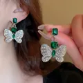 Close-up detail of butterfly earrings featuring green gemstones and sparkling rhinestones - Emerald Butterfly Style (8#) / Green/Silver