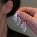 Detailed macro view of sparkling leaf-shaped silver needle dangle earrings with diamonds - Leaf Feather Dangle Style (42#) / Silver