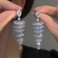 Detailed close-up of sparkling silver drop earrings with multi-layered teardrop zircons - Pear Shape Tassel Tiered (75#) / Silver