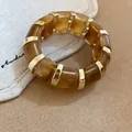 Elegant vintage amber marbled acrylic patchwork bracelet with gold-tone metal accents - Amber Brown