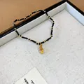 Elegant ethnic beaded bracelet featuring black and gold beads with a golden drop pendant - 147 Style (Conch) / 10mm (16 Beads) / Black
