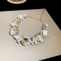 Close-up of fashion rhinestone necklace featuring square and water drop crystal cuts - Silver Base Clear Crystal