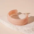 Detail shot of marbled peach acrylic cuff bracelet featuring a unique wide wavy design - 77# Round Bangle