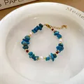 Blue crystal and pearl beaded bracelet in ethnic style with adjustable gold clasp - Irregular Crystal Pearl Style (197) / One Size / Blue-White-Red