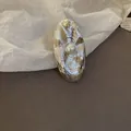 Detailed view of a vintage oval resin ring with textured silver finish and central pearl - Pearl Inlay / 48# Silver