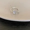Detailed view of a vintage minimalist silver open ring with a milky resin stone. - 51# Silver
