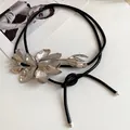 Detailed view of a vintage leather waist chain featuring a metal tulip ornament. - Tulip (WN1213) / Silver