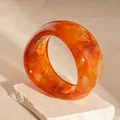 Elegant amber marbled acrylic wide bangle with an irregular wave design for women. - Style 7