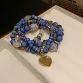 Mehrreihiges handgefertigtes blaues Perlenarmband mit einem goldenen Herzanhänger - 77# Armband - Blau - Herz (4er-set)