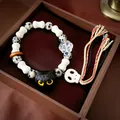Handgefertigtes Perlenarmband mit schwarzem Katzenkopf, Totenkopf und Dalmatiner-Steinen. - 142 Armband - Schwarz - Weiß
