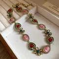 Close-up of vintage-style necklace featuring pink cameos, green hearts, and golden flowers - 2# Vintage Baroque Necklace - Green