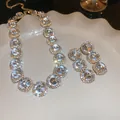 Detailed macro view of vintage rhinestone necklace and earrings with sparkling gems. - Gold-Tone Vintage Heavyweight Style (8#)