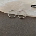 Minimalist silver geometric hoop earrings with a sleek polished finish for daily wear. - Ear Buckle / Silver