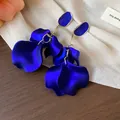 Elegant close-up view of royal blue acrylic petal drop earrings with gold finish detail - Gold / Blue