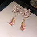 Exquisite macro detail of pink crystal floral drop earrings with elegant gold finish - Pink