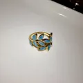 Detail shot of an elegant gold leaf open ring with blue glitter enamel finish jewelry - Open Style / Blue