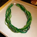 Close-up of multi-layer green crystal bead bracelet with sparkling rhinestone clasp - Necklace / Green