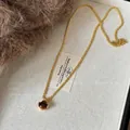 Close-up of vintage tiger eye bead pendant on golden rope chain necklace. - Style 15 / Gold Brown