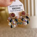 Detailed view of luxury geometric earrings with silver pins, pearls and colorful crystals. - Style 21 Vintage Drop