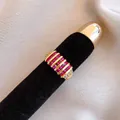 Elegant gold ring with square-cut pink ruby stones on a professional black velvet display - Ruby Color Row Rhinestone Style (30#)