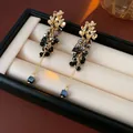 Elegant long flower tassel earrings featuring black crystal beads in a golden finish - Style 41 / Gold/Gray