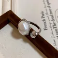 Close-up of a vintage luxury gold-plated open ring featuring a large irregular pearl - Adjustable (HR1905) / Silver