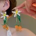 Elegant floral seed bead tassel earrings featuring white blossoms and orange fruit accents - 59# Ear Hook - White - Green - Orange