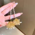 Elegante neue chinesische goldene Fächer-Ohrringe mit weißen Perlen und langen Quasten - Ohrhaken Stil (17)