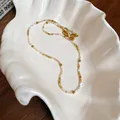 Collana bohémien retrò di perline colorate con accenti dorati su piatto a conchiglia - Collana No. 43 (Acciaio al Titanio Oro-Marrone)