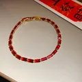 Detailed view of a vintage gold-plated bracelet with elegant red zircon stones - Red-Classic