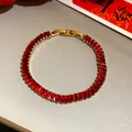 High-quality close-up of a vintage gold-plated bracelet with square red zircon stones - Gold-Red-Rectangle