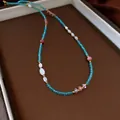 Elegante collana di perline retrò bohémien con pietre blu e rosa in finitura dorata - Collana No. 56 (Acciaio al Titanio Blu)