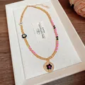 Collana bohémien vintage con perline e ciondolo a fiore in caldi toni oro e rosa - Collana No. 62 (Mix Giallo-Rosa)