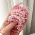 Close-up of 6-piece pink spiral hair ties in various cute patterns and textures. - 6pcs Set / Pink