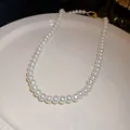Detailed view of elegant white pearl necklace on a ceramic display plate - 42# Necklace-Oval Pearl (HN4646) / White